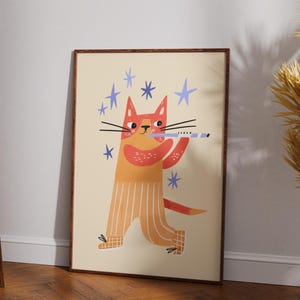May include: A framed art print featuring a whimsical illustration of a cat playing a flute. The cat is depicted in shades of orange and yellow with blue star accents. The artwork has a playful and cheerful aesthetic.