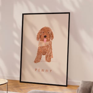 May include: A framed illustration of a brown dog with a patterned bandana. The dog is sitting and has its tongue sticking out. The dog's name, "PENNY", is written below the image.