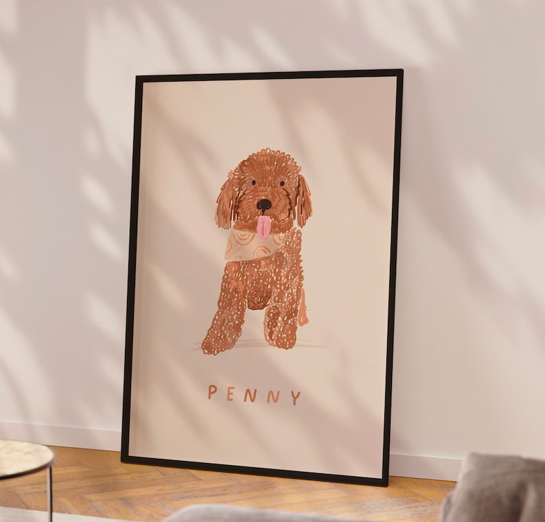 May include: A framed illustration of a brown dog with a patterned bandana. The dog is sitting and has its tongue sticking out. The dog's name, "PENNY", is written below the image.