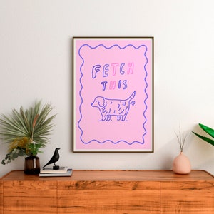 May include: A pink and blue illustrated print with a dog and the text "FETCH THIS".