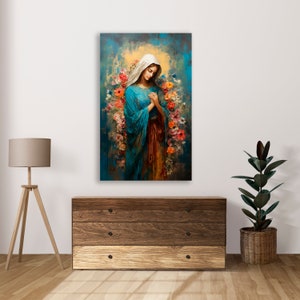 May include: A painting of a woman in a blue robe with a white veil, standing in a field of flowers. The woman is holding her hands together in prayer. The background is a soft blue and green.