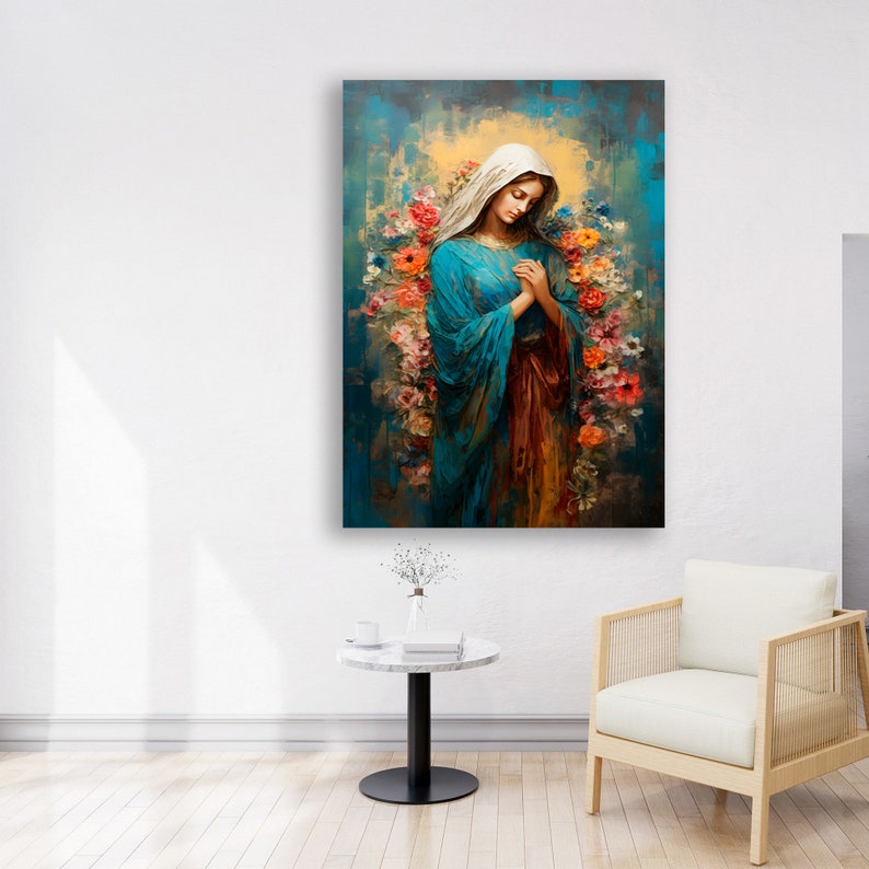 May include: A painting of a woman in a blue robe with a white veil, surrounded by colorful flowers. The woman is praying with her hands clasped together. The background is a blue and yellow abstract design.