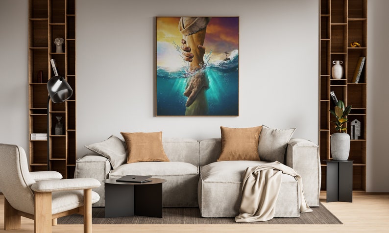 May include: A painting of a hand reaching out from the water to another hand. The painting is framed in a gold frame and is hanging on a wall in a living room.