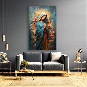 May include: A painting of a woman in a blue robe with her hands clasped in prayer. She is surrounded by flowers in shades of pink, red, and yellow. The background is a soft blue and yellow.