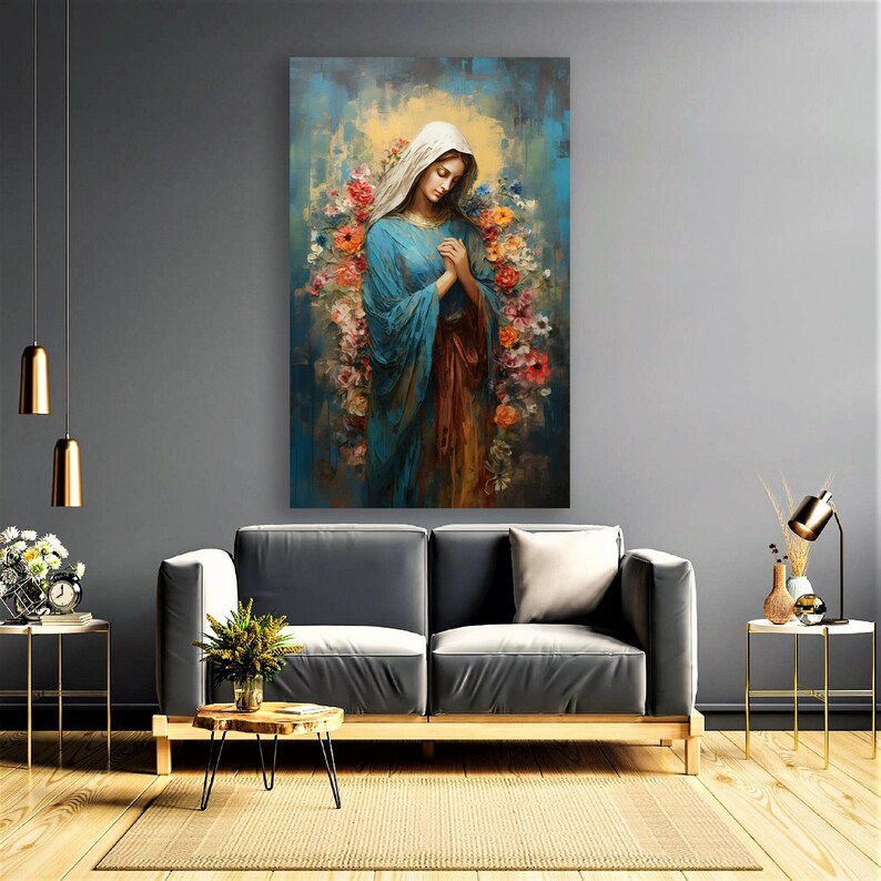 May include: A painting of a woman in a blue robe with her hands clasped in prayer. She is surrounded by flowers in shades of pink, red, and yellow. The background is a soft blue and yellow.