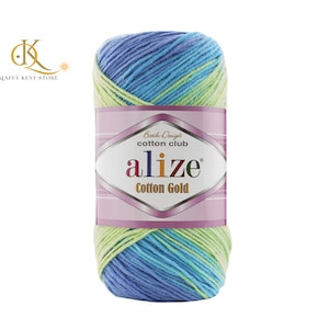 May include: A skein of Alize Cotton Gold yarn in shades of blue, green, and yellow. The yarn is wrapped with a label that reads "Alize Cotton Gold" and "Batik Design Cotton Club". The yarn is a blend of cotton and acrylic.