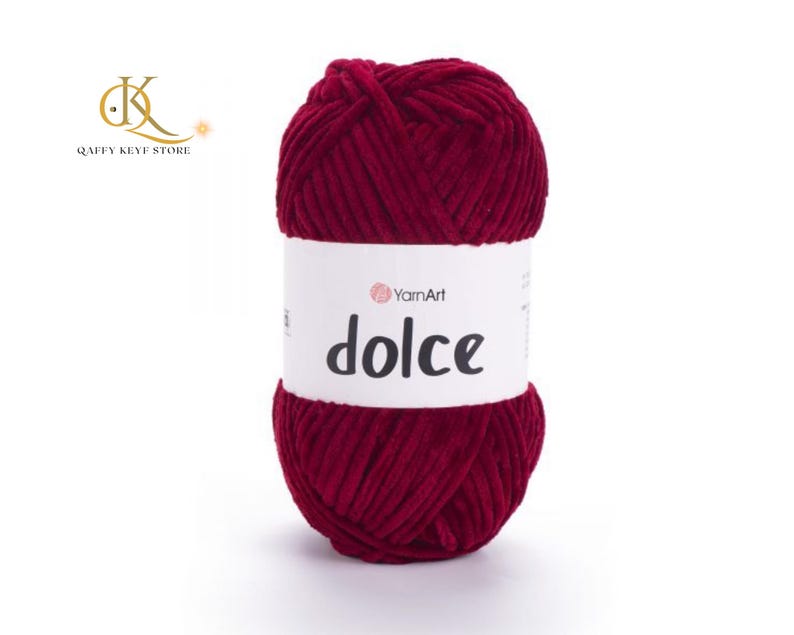 May include: A ball of deep red yarn with a white label that reads "dolce" in black text. The yarn is thick and appears soft. The brand name "YarnArt" is also visible on the label. This yarn is suitable for knitting and crochet projects.