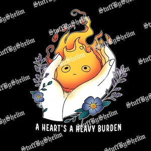 Op de afbeelding: Een digitale illustratie op een zwarte achtergrond toont een cartoon vuurduivel die in witte handen wordt gehouden. De vuurduivel is oranje en geel met een klein gezicht. Blauwe bloemen en paarse bladeren omringen de handen. De tekst "A HEART'S A HEAVY BURDEN" staat onderaan.