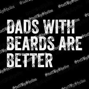 May include: Black background with the white text "DADS WITH BEARDS ARE BETTER". The text has a distressed, textured appearance. The words are stacked vertically, with "DADS" at the top and "BETTER" at the bottom.