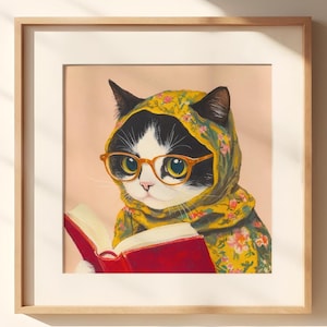 May include: A framed illustration of a cat wearing glasses and a floral headscarf, reading a red book.
