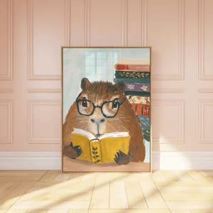 May include: A painting of a brown and white capybara wearing glasses and reading a yellow book. The capybara is sitting in front of a stack of colourful books.