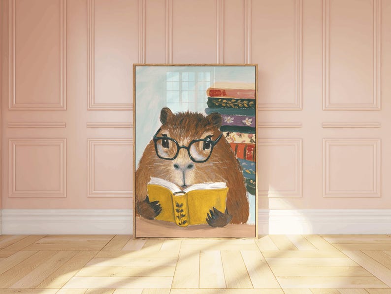 May include: A painting of a brown and white capybara wearing glasses and reading a yellow book. The capybara is sitting in front of a stack of colourful books.