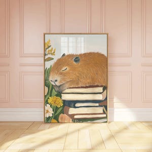 May include: A painting of a brown capybara sleeping on a stack of books. The capybara is surrounded by yellow flowers and green leaves.
