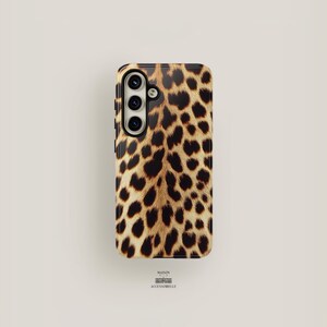 May include: A black phone case with a leopard print design. The case has a camera cutout and a raised lip around the edges.