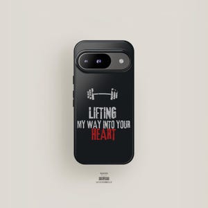 May include: Black phone case with the text "Lifting My Way Into Your Heart" in white and red, and a barbell graphic. The case is for a smartphone and has a camera cutout.