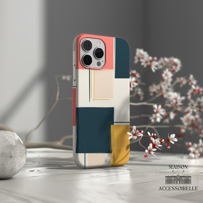 May include: A phone case with a geometric design featuring squares in shades of pink, yellow, blue, and white. The case has a camera cutout and a white background.