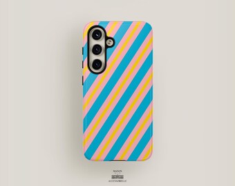 May include: A smartphone case with a colorful diagonal stripe pattern in blue, yellow, and pink. The case has a camera module with three lenses and a flash. The brand name "MAISON ACCESSOBELLE" is printed at the bottom.