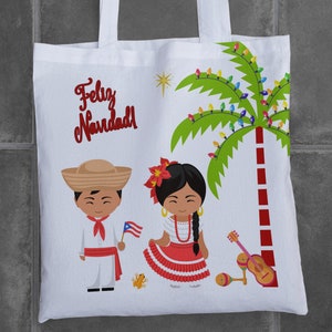 May include: A white tote bag with a Christmas-themed design featuring a palm tree with colorful lights, a man and woman in traditional Puerto Rican clothing, and the text "Feliz Navidad!" in red.