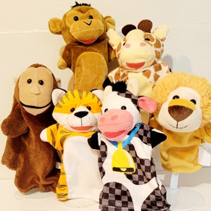 May include: A set of six plush animal hand puppets. The puppets include a monkey, giraffe, lion, tiger, cow, and a brown monkey. The puppets are all brown, yellow, orange, black, and white.