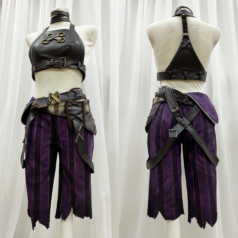 May include: A black leather halter top with gold accents and a matching belt. The top has a criss-cross design on the front. The belt has a buckle with a skull design. The outfit is paired with purple striped pants with black straps and buckles.