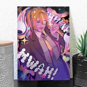 May include: A colourful art print depicting a person in a suit with a yellow tie, eye patch, and blonde ponytail. The artwork includes the word "MWAH!" in a playful font, surrounded by whimsical elements in a variety of colours.