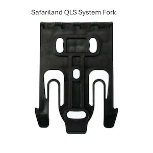May include: A black Safariland QLS System Fork. The fork has a rectangular shape with two oval holes at the top and two U-shaped hooks at the bottom. The text "Safariland QLS System Fork" is at the top.