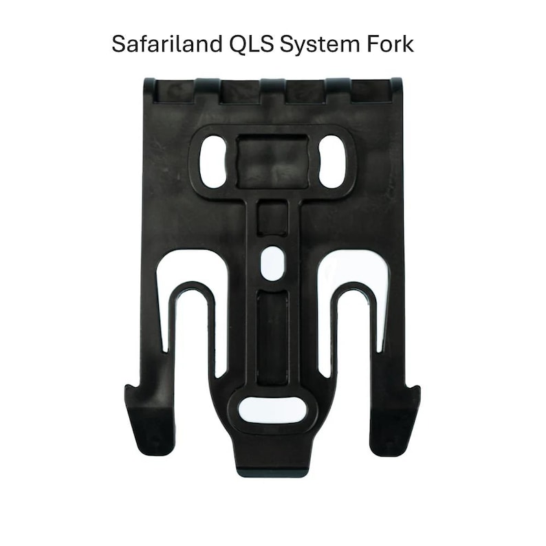 May include: A black Safariland QLS System Fork. The fork has a rectangular shape with two oval holes at the top and two U-shaped hooks at the bottom. The text "Safariland QLS System Fork" is at the top.