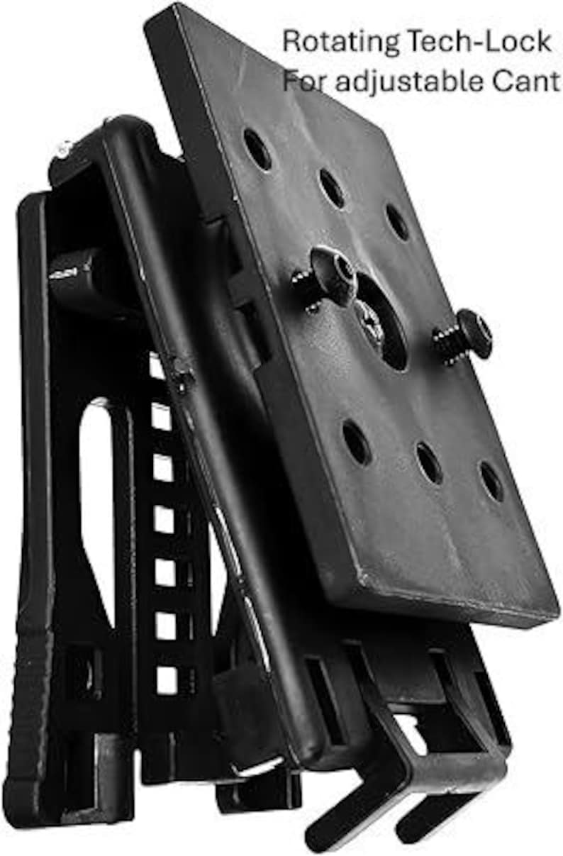 May include: Black Tech-Lock mount with adjustable cant. The mount features a rectangular plate with multiple holes and two screws. The text "Rotating Tech-Lock For adjustable Cant" is visible.