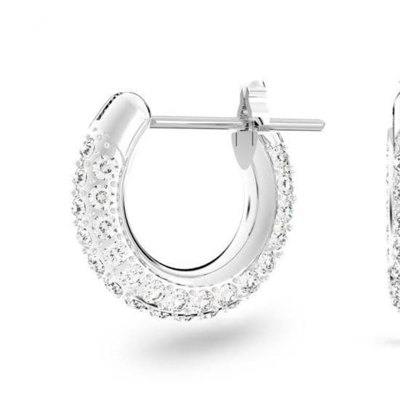 K&ouml;nnte beinhalten: Silberne Creolen mit einem klaren Kristall-Pave-Design.