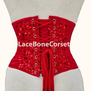 May include: Red corset with a lace-up back and sequins. The corset has a red lace-up closure and the text "LaceBoneCorset" is printed on the back.