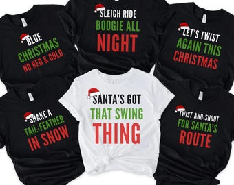 May include: A collection of black and white t-shirts with Christmas-themed phrases in red and green text. Each shirt features a Santa hat graphic. Phrases include "Blue Christmas No Red & Gold", "Sleigh Ride Boogie All Night", and "Santa's Got That Swing Thing".
