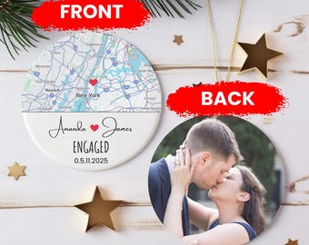 May include: A personalized Christmas ornament with a map of New York City on the front and a photo of a couple kissing on the back. The front also includes the names "Amanda & James", the word "ENGAGED", and the date "0.5.11.2025".