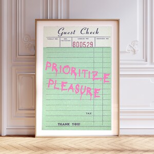 May include: A green guest check with the text "PRIORITIZE PLEASURE" written in pink. The check number is 800529.