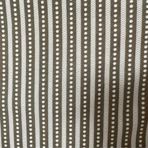 May include: Close-up of a fabric with a repeating pattern. The design features vertical stripes in a dark olive-green color, alternating with white stripes. The white stripes have a dotted and chevron pattern.
