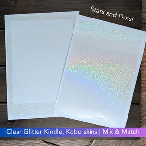 May include: Two clear, iridescent glitter sheets for customizing Kindle and Kobo e-readers. One sheet has a solid glitter pattern, while the other has a "Stars and Dots!" pattern.
