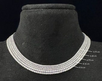 May include: A diamond tennis chain necklace with five rows of diamonds. The necklace is 16 inches long and weighs 16.15 grams. The chain is displayed on a black mannequin bust.