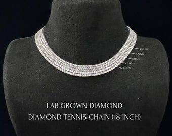 May include: A silver-toned lab grown diamond tennis chain necklace measuring 18 inches in length. The piece features five rows of stones with labeled carat weights of 4.50, 5.50, 8.00, 9.00, and 11.00 cts. Text reads: LAB GROWN DIAMOND DIAMOND TENNIS CHAIN (18 INCH).