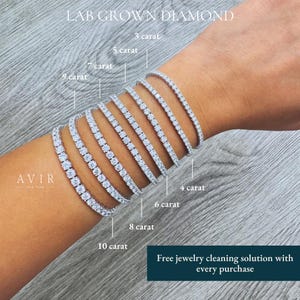 May include: A collection of eight silver-toned tennis bracelets featuring lab-grown diamonds, labeled from 3 carat to 10 carat. The text AVIR NEW YORK is visible, along with the text Free jewelry cleaning solution with every purchase.