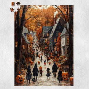 May include: A Halloween-themed jigsaw puzzle depicting a festive street scene. The image shows a cobblestone road lined with houses and trees in autumn colors. People in costumes and carved pumpkins are scattered throughout the scene.