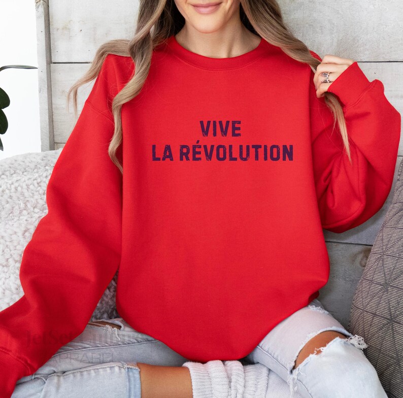 May include: Red sweatshirt with the text "VIVE LA R&Eacute;VOLUTION" in dark blue.