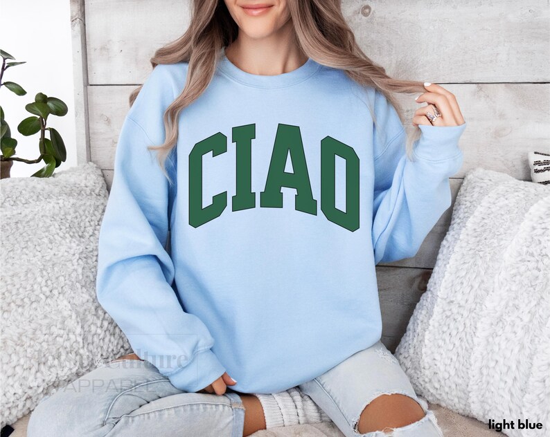 May include: Light blue sweatshirt with the word "CIAO" in green letters.
