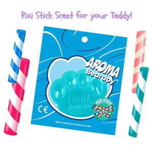 May include: A blue paw-shaped silicone toy with the text "AROMA Bearapy" on it. The toy is packaged with a small bag of colorful pixie sticks. The packaging has the text "Pixie Sticks Scent for your Teddy!" on it.