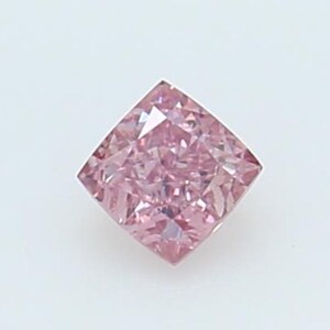 May include: A square-cut gemstone with a vibrant pink hue and multiple facets that create a reflective, sparkling appearance. The stone is oriented with one corner pointing upward, showcasing its geometric shape and clear, crystalline structure.
