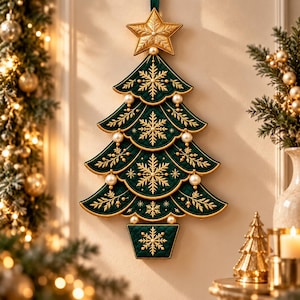 May include: A wall-hanging Christmas tree decoration made of dark green quilted fabric with gold embroidered snowflakes and branch patterns. The tree is topped with a gold star and features white pearl-like beads along the scalloped edges.