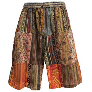 May include: Patchwork shorts in a variety of colors including orange, brown, and green. The shorts have an elastic waistband with a drawstring. The fabric is a mix of patterned and solid patches.