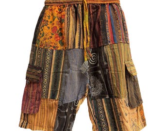 May include: Patchwork shorts featuring an elastic waistband with a drawstring. The garment is constructed from various fabric panels in shades of orange, brown, black, and blue, displaying diverse patterns including stripes, floral prints, and symbols.