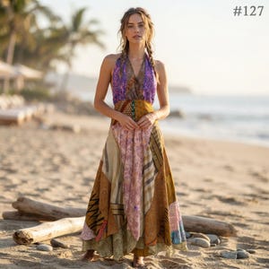 May include: A floor-length halter dress featuring a patchwork design with various patterns and colors including purple, gold, brown, and tan. The garment has a V-neckline and a flowing skirt with multiple fabric panels. The text #127 is visible.