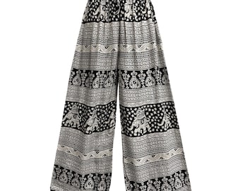 May include: Black and white patterned palazzo pants. The pants feature an elastic waistband and a wide leg design. The pattern includes elephants, stars, and other decorative elements. The pants are made of a lightweight fabric.