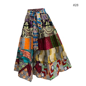 May include: A patchwork skirt with a vibrant mix of colors and patterns. The skirt features a variety of fabric designs, including geometric shapes, floral motifs, and abstract patterns. The skirt has a tie-waist design and a flared silhouette.