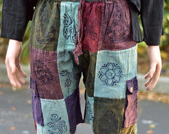 May include: Patchwork shorts with a variety of colors and patterns, including blue, green, red, and purple. The shorts have a drawstring waist and two side pockets.